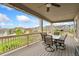 The covered deck has an outdoor dining set, ceiling fan, and nice views of the neighborhood at 19316 W 84Th Pl, Arvada, CO 80007
