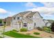 Exterior view featuring three-car garage, beautiful lawn, and stylish architectural details at 19316 W 84Th Pl, Arvada, CO 80007
