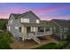 Exterior elevation of a grey two-story home with a covered patio and gravel landscaping at 19316 W 84Th Pl, Arvada, CO 80007