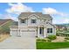 Charming two-story home featuring a three-car garage, and well-manicured lawn at 19316 W 84Th Pl, Arvada, CO 80007