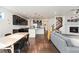Open-concept living area featuring a modern kitchen, cozy fireplace, and staircase at 19316 W 84Th Pl, Arvada, CO 80007