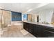 The bathroom features double sinks, a large mirror, a soaking tub, and a walk-in shower at 19316 W 84Th Pl, Arvada, CO 80007