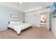 The main bedroom features ample space, a stylish accent wall, and an en-suite bathroom at 19316 W 84Th Pl, Arvada, CO 80007