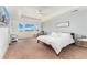 Bright main bedroom with tray ceiling, plush carpet, and large windows overlooking scenic views at 19316 W 84Th Pl, Arvada, CO 80007