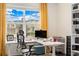 Bright office space featuring large window, with mountain views, and modern desk at 19316 W 84Th Pl, Arvada, CO 80007