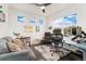 Comfortable home office with sofa, large windows, and modern desk setup at 19316 W 84Th Pl, Arvada, CO 80007