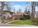Charming brick home featuring a landscaped front yard and inviting walkway at 1665 S Saint Paul St, Denver, CO 80210