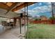 Spacious backyard with patio, seating, and green lawn at 7747 Quivas St, Denver, CO 80221