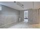 Unfinished basement with painted walls, light tile flooring, and an open doorway at 7747 Quivas St, Denver, CO 80221