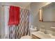 Clean bathroom with a shower/tub combo, patterned shower curtain, and a single-sink vanity at 7747 Quivas St, Denver, CO 80221