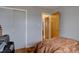 Simple bedroom featuring hardwood floors, a closet with light gray walls and open entrance at 7747 Quivas St, Denver, CO 80221