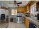 Functional kitchen featuring stainless steel appliances, light wooden cabinetry, and tiled backsplash at 7747 Quivas St, Denver, CO 80221