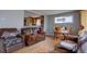 Inviting living space with hardwood floors, comfortable seating, and an adjacent dining area at 7747 Quivas St, Denver, CO 80221