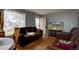 Cozy living room with hardwood floors, a large window, and a comfortable seating arrangement at 7747 Quivas St, Denver, CO 80221