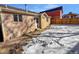 Brick home with a fenced backyard partially covered in snow at 4169 S Lewiston St, Aurora, CO 80013