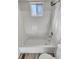 Clean bathroom with white tile and a shower/tub combo at 4169 S Lewiston St, Aurora, CO 80013