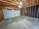 Unfinished garage with overhead door and concrete floor at 4169 S Lewiston St, Aurora, CO 80013