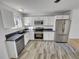 Kitchen with stainless steel appliances and white shaker cabinets at 4169 S Lewiston St, Aurora, CO 80013