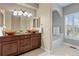 Elegant bathroom with dual sinks, granite countertops, and a separate tub and shower at 3773 S Dayton Way, Aurora, CO 80014