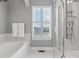 Luxurious bathroom featuring a soaking tub and a glass-enclosed shower at 3773 S Dayton Way, Aurora, CO 80014