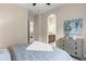 Bedroom featuring an arched doorway and a view into the attached bath at 3773 S Dayton Way, Aurora, CO 80014