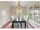 Bright dining room with a modern chandelier and large windows providing ample natural light at 3773 S Dayton Way, Aurora, CO 80014