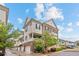 Charming townhome with brick accents, a private balcony, a two-car garage, and landscaped front yard at 3773 S Dayton Way, Aurora, CO 80014
