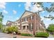 Beautiful brick townhome showcasing manicured landscaping and a welcoming entrance at 3773 S Dayton Way, Aurora, CO 80014