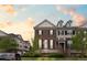 Attractive townhome with a brick facade, well-manicured lawn, and a welcoming front porch at 3773 S Dayton Way, Aurora, CO 80014