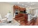 Eat-in kitchen with rich wood floors, stainless appliances, and an island with bar seating at 3773 S Dayton Way, Aurora, CO 80014