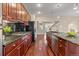 Gourmet kitchen features dark wood cabinetry, stainless steel appliances, and granite countertops at 3773 S Dayton Way, Aurora, CO 80014