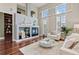 Bright living room featuring a fireplace with built-ins, hardwood floors, and large windows with shutters at 3773 S Dayton Way, Aurora, CO 80014