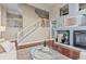 Spacious living room featuring a fireplace, staircase, hardwood floors and neutral décor at 3773 S Dayton Way, Aurora, CO 80014