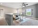 Bright living room with large window, ceiling fan, and stylish decor at 3773 S Dayton Way, Aurora, CO 80014
