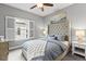 Cozy bedroom with a tufted headboard, shuttered window, and bedside lamps at 3773 S Dayton Way, Aurora, CO 80014