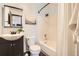 Bathroom featuring a vanity, mirror, and shower/tub combination at 444 Vance St, Lakewood, CO 80226