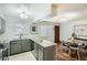 Open-concept kitchen with granite countertops and stainless steel appliances adjacent to dining area at 444 Vance St, Lakewood, CO 80226