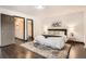 Serene main bedroom featuring a king-size bed and ensuite bathroom at 444 Vance St, Lakewood, CO 80226