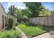 Private backyard with a lush green lawn and seating, surrounded by a wooden fence at 756 Steele St, Denver, CO 80206