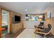 Basement featuring a seating area with modern chairs, a TV, and neutral-colored walls at 756 Steele St, Denver, CO 80206