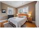 Cozy bedroom with hardwood floors, a decorative radiator, and a comfortable bed with an upholstered headboard at 756 Steele St, Denver, CO 80206