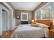 Cozy bedroom with hardwood floors, a decorative radiator, and a comfortable bed with an upholstered headboard at 756 Steele St, Denver, CO 80206