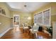 Bright dining room featuring hardwood floors, large windows, and a modern glass dining table at 756 Steele St, Denver, CO 80206