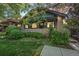 Charming brick home featuring a cozy porch and lush landscaping, perfect for enjoying the outdoors at 756 Steele St, Denver, CO 80206