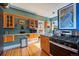 A kitchen with stainless appliances, wood cabinetry and countertops, and bright sunlight at 756 Steele St, Denver, CO 80206