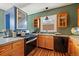 Cozy kitchen featuring stainless steel appliances, wood cabinets, and a gas stove with plenty of natural light at 756 Steele St, Denver, CO 80206