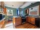 A well lit kitchen featuring hardwood floors, stainless steel appliances and updated wooden cabinetry at 756 Steele St, Denver, CO 80206