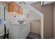 Functional laundry room with a washer, dryer, storage cabinet, and cleaning supplies at 756 Steele St, Denver, CO 80206