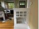 Living room with built-in display cabinet, hardwood floors, modern chairs, and view of front door at 756 Steele St, Denver, CO 80206