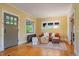 Bright living room featuring hardwood floors, a cozy seating area, and a view to a cozy office at 756 Steele St, Denver, CO 80206